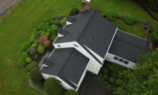 aerial view of a house with newly installed roof shingles